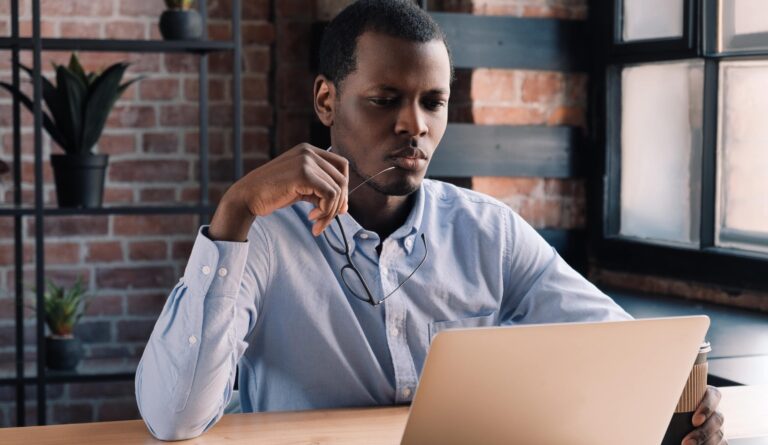 man looking at computer with confused expression because of medical device branding mistakes