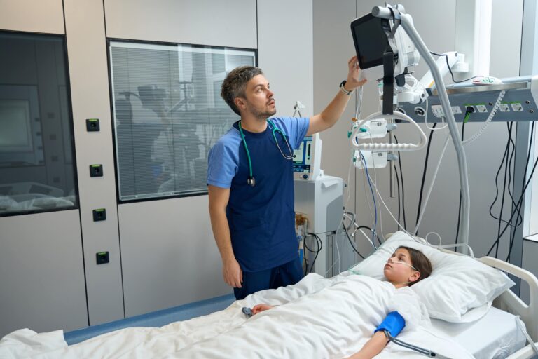 medical device imagery of doctor using device to monitor patient